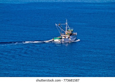 Fishing Trawler On Open Blue Water Aerial View