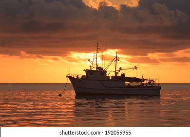 Fishing trawler at sunset