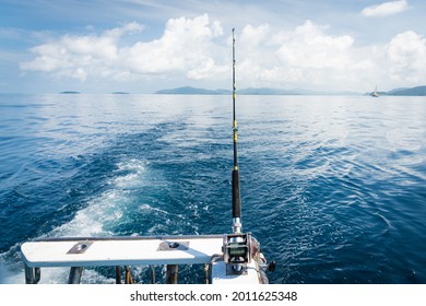 Fishing Trolling Tuna With Speedboat On Pacific Ocean. Fishing Reel Tackle Spinning Fishing Rod On Boat. Big Game Fishing Reels On Ocean.  Blue Sea Sky. 