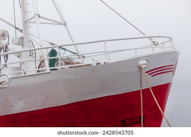 Fishing vessel in a foggy misty morning at Harbor - Powered by Shutterstock