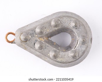 A Fishing Weight With An Eye For Attaching A Fishing Line On A White Background. Closeup. Located Vertically