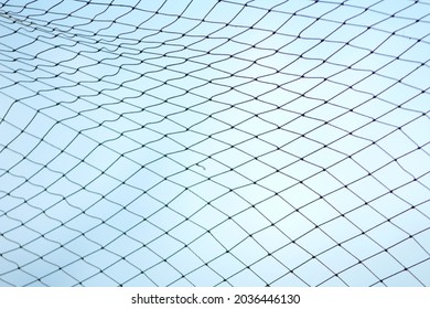 Fishnet Texture On A Blue Sky Background With Copy Space