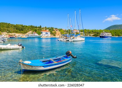 FISKARDO PORT, KEFALONIA ISLAND, GREECE - SEP 16, 2014: traditional Greek fishing boat in port of FIskardo village. Colorful boats are symbol of Greek islands. 
