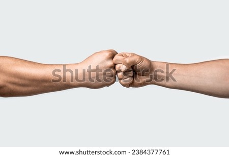 Fist bump. Clash of two fists, vs. Gesture of giving respect or approval. Friends greeting. Teamwork and friendship. Partnership concept. Mans are fist bumping.