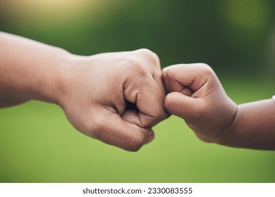 Fist bump, hands of baby and father with support together or gesture of success or trust in family on blurred background. Hand, bumping fists and dad with son or sign of solidarity or celebration - Powered by Shutterstock