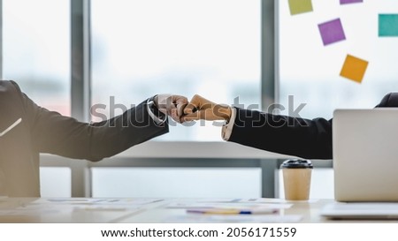 Fist bumping of business people as corporate success on job agreement, achieve great deal of task, glad on accomplishment of project contract from work appointment at conference room in company office