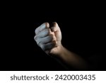 fist, Hand gesture. man clenched fist, ready to punch, isolated on black, close-up, copy space