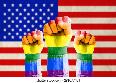 Fist Hand With Rainbow Flag Patterned On Flag Of United States Of America Background - Homosexual, Gay And Love Concept - US Supreme Court Rules Gay Marriage Is Legal Nationwide