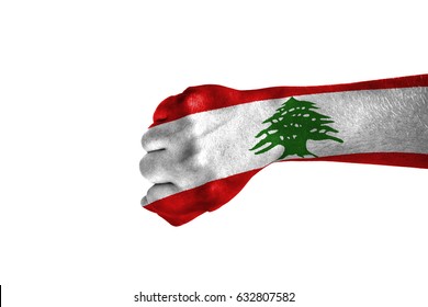 Fist painted in color Lebanon flag, hand isolated on white background.