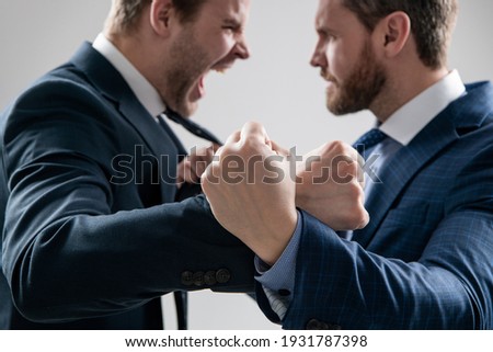 fist of punching disagreed men business partners or colleague disputing and fighting aggressive and angry while conflict, selective focus, corporate battle.
