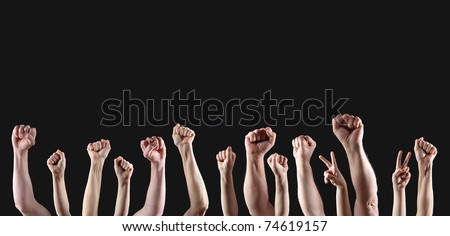 Fists raised in protest on a dark gray background