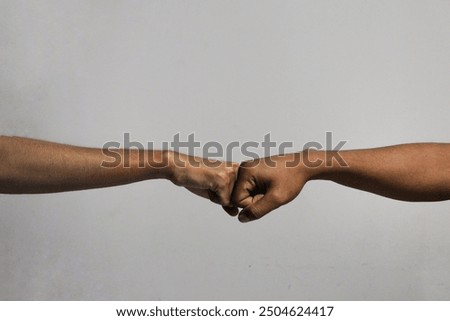 Fists touching. Two friendly hands touch each other's knuckles as a sign of cooperation and agreement.