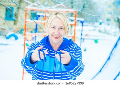 Fit Active Old Blond Woman Performing Training And Doing Her Warming Up Exercise With Jumping Rope Outdoors Snowy Winter