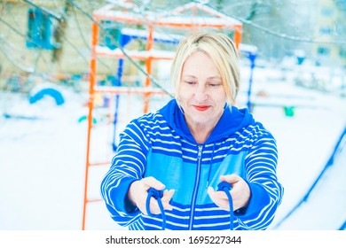 Fit Active Old Blond Woman Performing Training And Doing Her Warming Up Exercise With Jumping Rope Outdoors Snowy Winter