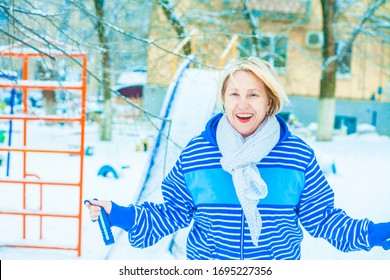 Fit Active Old Blond Woman Performing Training And Doing Her Warming Up Exercise With Jumping Rope Outdoors Snowy Winter