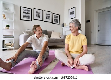 Fit Active Retired Middle Aged Wife And Senior Husband Having Fun Doing Stretching Exercise At Home. Happy Healthy Older Senior 60s Couple Enjoying Fitness Sport Training Workout Together In Apartment