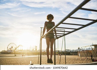 fit african american woman exercising on monkey bars - Powered by Shutterstock