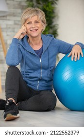 Fit Aged Woman Holding Big Blue Exercise Ball