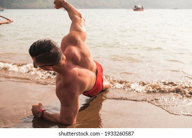 A Fit Asian Man Does Side Planks At The Beach. Core Oblique Workout Or Calisthenics Outdoors.