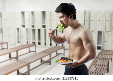 Fit Asian Man Losing Weight By Eating Salad In Gym.