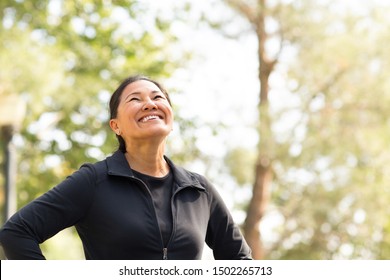 Fit Asian Woman Exercising And Walking Outside