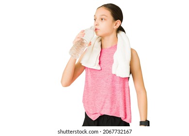 Fit Beautiful Girl With A Towel Taking A Break From Her Workout And Drinking Water. Tired Active Teen Resting From Exercise