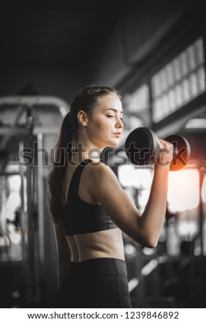 Similar – young adult trained woman concentrate at her excercise in gym