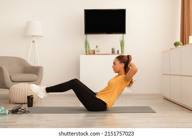 Fit Black Lady Exercising Doing Abs Crunches Flexing Abdominal Muscles On Gymnastic Mat At Home, Side View. Bodybuilding Workout And Fitness Lifestyle Concept