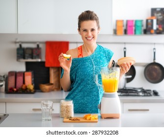 A fit brunette smiles happily as she is adding apple to her freshly-made smoothie. Nothing like a boost of vitamins to round out your workout... - Powered by Shutterstock