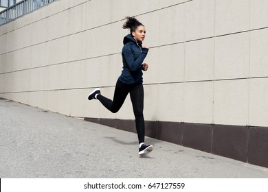 Fit Brunette Woman Running In The City