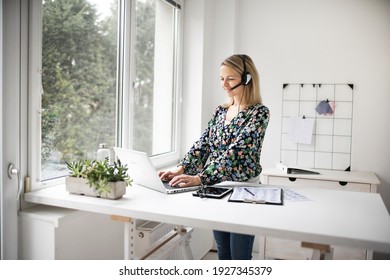 Fit Businesswoman Working At Ergonomic Standing Desk