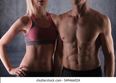Fit couple, strong muscular man and slim woman . Sport, fitness ,workout concept.