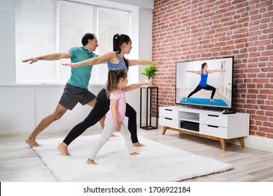 Fit Family Doing Home Online Stretching Yoga Fitness Exercise - Powered by Shutterstock