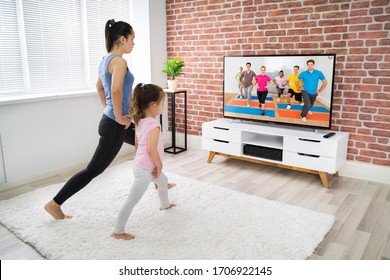 Fit Family Doing Online Yoga Fitness Exercise At Home