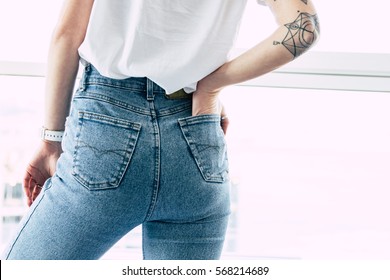 Fit Female Butt In Jeans. Hand With Tattoos In Pocket