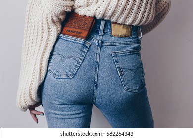 Fit Female Butt In Jeans With Passport In Pocket And Oversized Sweater