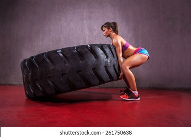 Fit female flipping tire at the gym. - Powered by Shutterstock