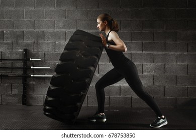 Fit female flipping tire at the gym. - Powered by Shutterstock