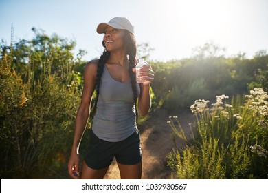 Fit Female Hiker Taking A Break To Drink Water From Waterbottle