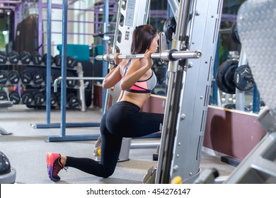 Fit Girl Doing Lunges With The Smith Machine