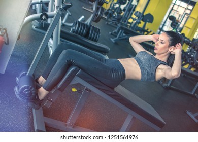 Fit Girl Doing Push-ups On Exercise Machine In Gym