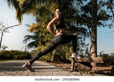 Fit Girl Doing Standing Hamstring Stretch After A Run In Nature