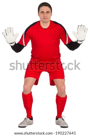 Fit goal keeper looking at camera on white background