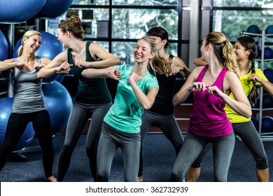 Fit Group Dancing And Smiling In The Gym