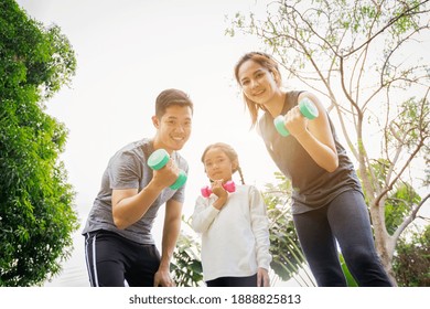 Fit happy people working out outdoor. Portrait Family Asian parent and child daughter exercising together on a yoga mat at home garden. Family outdoors. exercise at the home concept and new normal.

 - Powered by Shutterstock