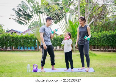 Fit happy people working out outdoor. Family Asian parent and child daughter exercising together on a yoga mat at home garden. Family outdoors. exercise at the home concept and new normal.

 - Powered by Shutterstock