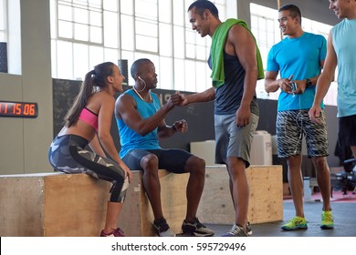 Fit Healthy Mixed Race Man Greeting His Friend In The Gym Before Workout Crossfit Class