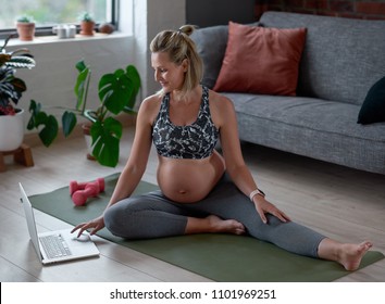 Fit healthy pregnancy, happy pregnant woman maintaining fitness following simple exercises online on laptop
