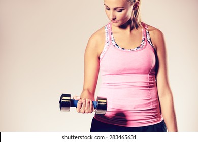 Fit And Healthy Woman Standing Working Out Upper Body, Doing A Bicep Curl.