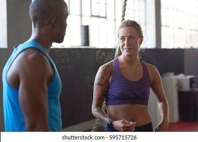 Fit Lean Man And Healthy Woman With Tattoos Talking In Gym Before Crossfit Class, Exercise Fitness Concept